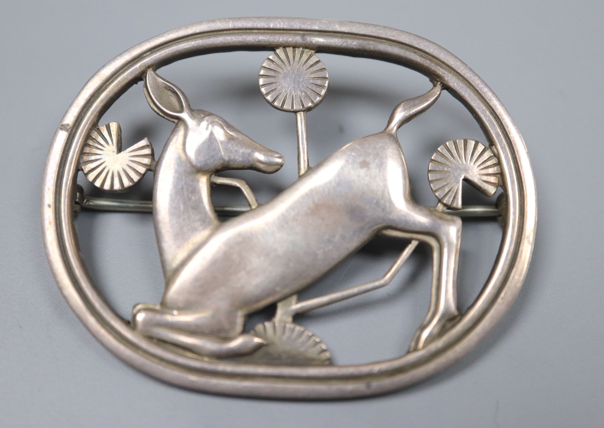 A 1960s Georg Jensen silver kneeling deer oval brooch, no. 256, designed by Arno Malinowski, 45mm.